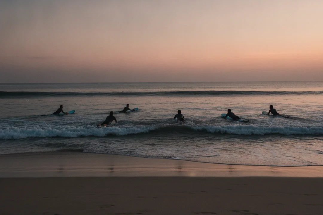 Campers paddling out together at dawn in Canggu